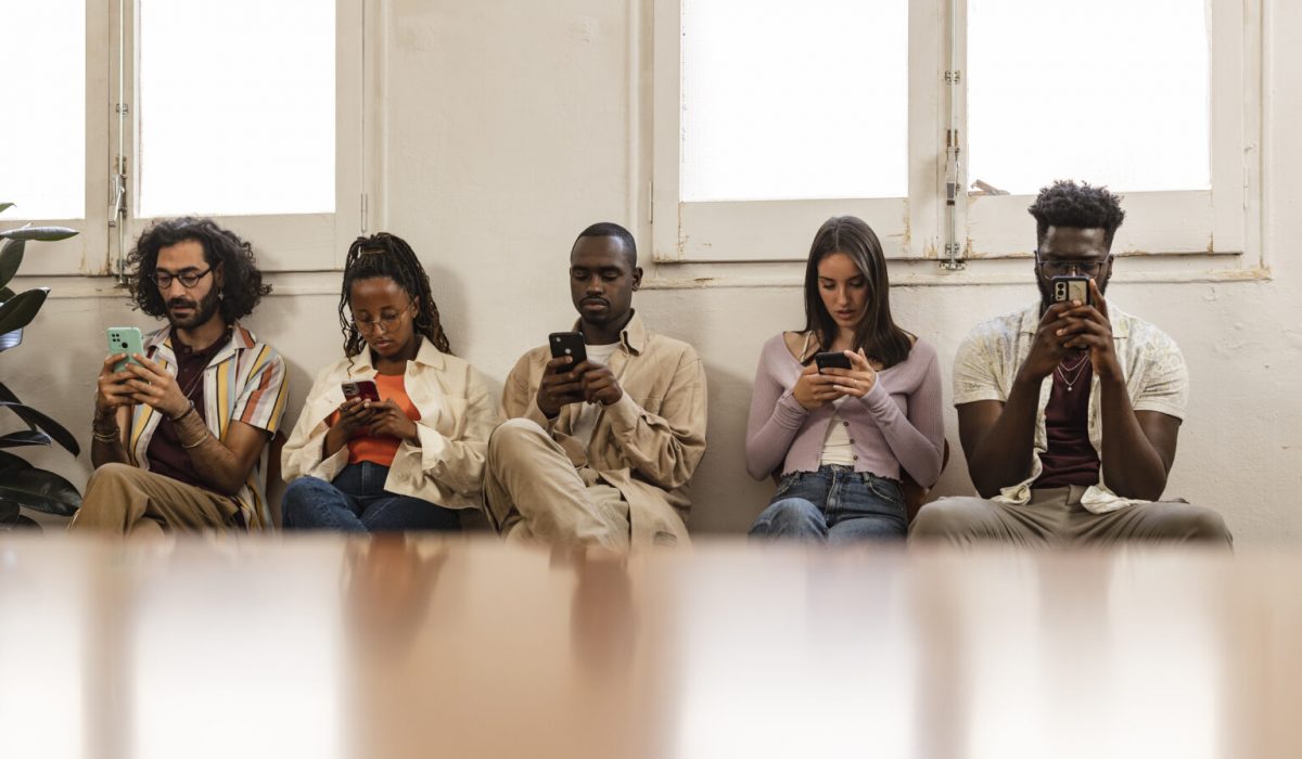 people in a waiting room using smart phone - technology addiction -